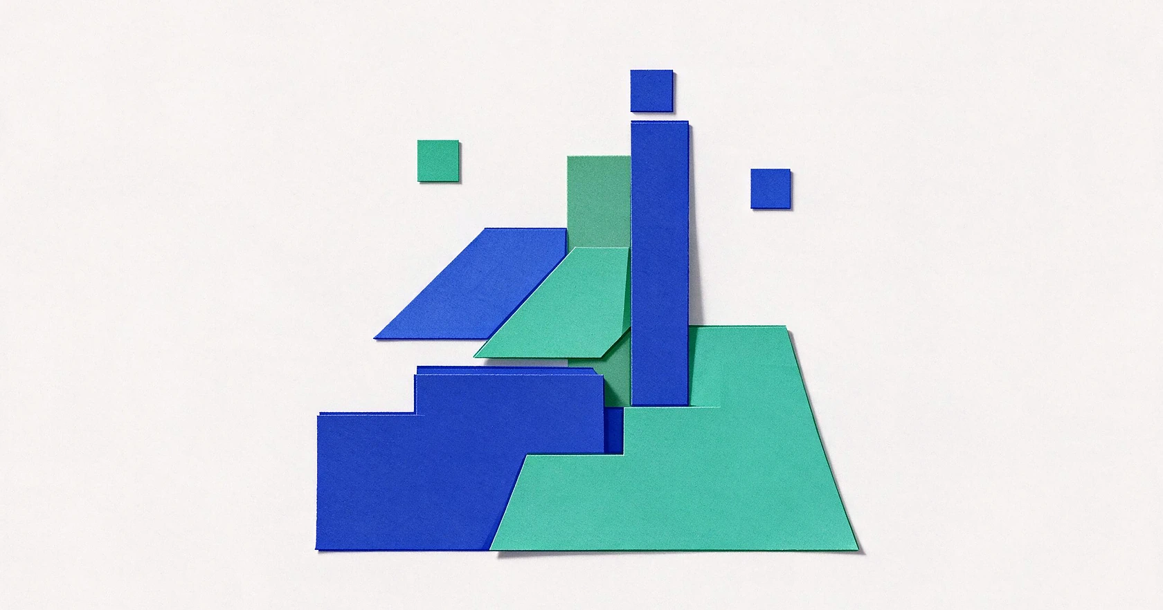 Paper-like shapes in brand colors are arranged on a light surface, suggesting different pricing tiers.